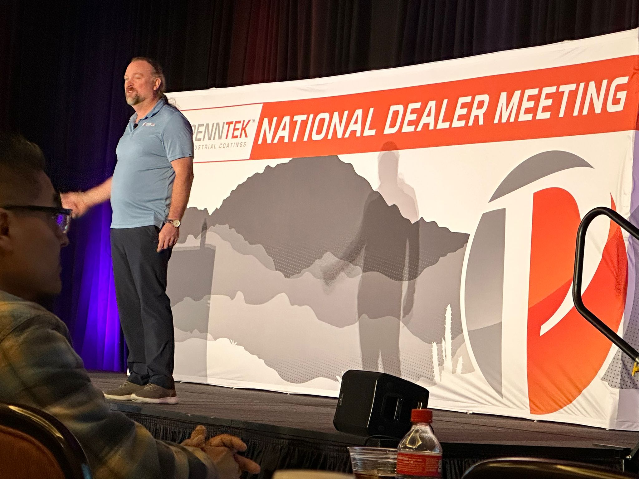 National dealer meeting stage with branded presentation visuals